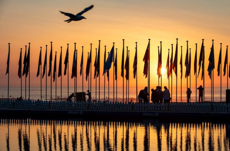 The sailing race venue lined with national flags at sunset